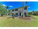 Charming townhouse features a lush green lawn, mature trees, and a welcoming entrance at 311 Cape Harbour Loop # 108, Bradenton, FL 34212