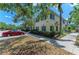 Townhouse exterior featuring well-maintained landscaping, sidewalks, and ample parking, with a blue sky backdrop at 311 Cape Harbour Loop # 108, Bradenton, FL 34212