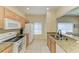 Well-lit kitchen featuring a range, microwave, refrigerator, and granite countertops for easy cooking and cleanup at 311 Cape Harbour Loop # 108, Bradenton, FL 34212
