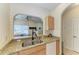 Granite countertops and a view of the dining area enhance the kitchen sink space at 311 Cape Harbour Loop # 108, Bradenton, FL 34212