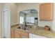 Kitchen sink with granite countertops and a view of the dining area through an arched opening at 311 Cape Harbour Loop # 108, Bradenton, FL 34212
