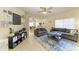 Open-concept living room with comfortable sofas, ceiling fan, and a view of the dining area at 311 Cape Harbour Loop # 108, Bradenton, FL 34212