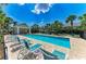 Inviting community pool surrounded by palm trees and lounge chairs, perfect for relaxation at 311 Cape Harbour Loop # 108, Bradenton, FL 34212