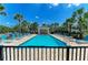 Gorgeous community pool with plenty of lounge seating, surrounded by lush landscaping and palm trees at 311 Cape Harbour Loop # 108, Bradenton, FL 34212