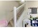 Carpeted staircase with white banister and a cozy nook with decorations and toys at 311 Cape Harbour Loop # 108, Bradenton, FL 34212