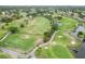Scenic aerial shot of the golf course surrounded by lush green fairways and sparkling water features at 3130 Ringwood Mdw # 44, Sarasota, FL 34235