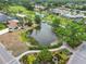 Aerial view of a lake in a golf course community with walkways and beautiful landscaping at 3130 Ringwood Mdw # 44, Sarasota, FL 34235