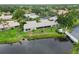 Aerial view of a lakefront home with bridge access and lush landscaping along waterfront at 3130 Ringwood Mdw # 44, Sarasota, FL 34235