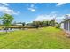 Expansive backyard featuring a pond, mature trees, and well-maintained lawn at 3130 Ringwood Mdw # 44, Sarasota, FL 34235