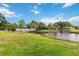 Scenic backyard view featuring a pond, bridge, and lush landscaping at 3130 Ringwood Mdw # 44, Sarasota, FL 34235