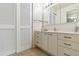 Bathroom featuring carpet, white cabinets, a sink and an oversized mirror at 3130 Ringwood Mdw # 44, Sarasota, FL 34235