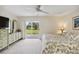 Primary bedroom features a queen bed, ceiling fan, ensuite access and sliding glass doors to the backyard at 3130 Ringwood Mdw # 44, Sarasota, FL 34235