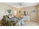 Comfortable bedroom featuring a ceiling fan, soft lighting, and beachy decor at 3130 Ringwood Mdw # 44, Sarasota, FL 34235