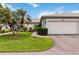 Charming single-story home featuring a two-car garage, lush landscaping, and a well-manicured lawn at 3130 Ringwood Mdw # 44, Sarasota, FL 34235