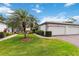 Beautiful home exterior with a two-car garage, lush landscaping, and a paved walkway at 3130 Ringwood Mdw # 44, Sarasota, FL 34235