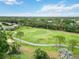 Aerial view of the lush golf course with palm trees, sidewalks and mature trees at 3130 Ringwood Mdw # 44, Sarasota, FL 34235
