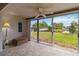 Enclosed lanai with tile floor, ceiling fan and sliding doors with a view of the backyard and pond at 3130 Ringwood Mdw # 44, Sarasota, FL 34235