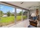Enclosed lanai with tile floor, ceiling fan and sliding doors with a view of the backyard and pond at 3130 Ringwood Mdw # 44, Sarasota, FL 34235