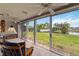 Enclosed lanai with tile floor, ceiling fan and sliding doors with a view of the backyard and pond at 3130 Ringwood Mdw # 44, Sarasota, FL 34235