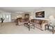 Spacious living room with neutral carpet, comfortable sofas, and a view into the dining area at 3130 Ringwood Mdw # 44, Sarasota, FL 34235