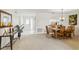 Bright living room with neutral carpet, dining area, and a view of the front entrance at 3130 Ringwood Mdw # 44, Sarasota, FL 34235