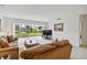 Bright living room featuring neutral carpet, sliding glass doors with backyard views, and comfortable seating at 3130 Ringwood Mdw # 44, Sarasota, FL 34235