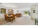 Open living and dining space with neutral carpet, sliding glass doors, and comfortable seating at 3130 Ringwood Mdw # 44, Sarasota, FL 34235