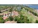 A tranquil aerial view showcases homes by a golf course, a pond, and the bay in the distance at 3412 E Chelmsford Ct # 42, Sarasota, FL 34235