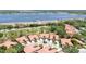 Aerial view of community homes, golf course, and lake in the distance at 3412 E Chelmsford Ct # 42, Sarasota, FL 34235