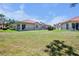 Expansive backyard with lush green grass, perfectly manicured landscaping, and a beautiful home exterior at 3412 E Chelmsford Ct # 42, Sarasota, FL 34235