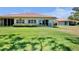 Lush backyard with well-maintained lawn and attractive home exterior featuring a terra cotta roof at 3412 E Chelmsford Ct # 42, Sarasota, FL 34235
