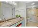 Granite vanity with shower and toilet behind glass door in spacious bathroom at 3412 E Chelmsford Ct # 42, Sarasota, FL 34235