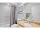Well-lit bathroom with granite countertop, framed art, and shower with curtain at 3412 E Chelmsford Ct # 42, Sarasota, FL 34235