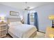 Cozy bedroom with light blue walls, ceiling fan, window with blinds, and comfortable bedding at 3412 E Chelmsford Ct # 42, Sarasota, FL 34235