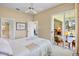 Bedroom with neutral walls leading to a sunny lanai through sliding glass doors at 3412 E Chelmsford Ct # 42, Sarasota, FL 34235