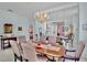 Formal dining room features a long wooden table with seating for six, light paint, and a chandelier at 3412 E Chelmsford Ct # 42, Sarasota, FL 34235