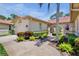 Exterior of home showcasing landscaped walkway with decorative metal entry gate at 3412 E Chelmsford Ct # 42, Sarasota, FL 34235