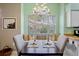 Eat-in kitchen featuring a chandelier, white cabinets, stainless steel appliances, and a window seat at 3412 E Chelmsford Ct # 42, Sarasota, FL 34235
