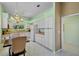 Open kitchen boasts white cabinets, modern appliances, and a breakfast bar with views of the backyard at 3412 E Chelmsford Ct # 42, Sarasota, FL 34235