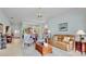 Spacious living room featuring neutral paint, tile floors, and views of backyard at 3412 E Chelmsford Ct # 42, Sarasota, FL 34235