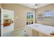 Comfortable bedroom with natural light, golf course views, and doorway to the living space at 3412 E Chelmsford Ct # 42, Sarasota, FL 34235