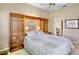 Comfortable bedroom with built in shelving and ensuite bathroom entrance at 3412 E Chelmsford Ct # 42, Sarasota, FL 34235