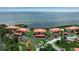 Panoramic aerial view of waterfront condos with red tile roofs, landscaped grounds, and bay views at 3420 Wild Oak Bay Blvd # 120, Bradenton, FL 34210
