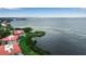 Aerial view of waterfront condos with red tile roofs and lush green shoreline and waterway at 3420 Wild Oak Bay Blvd # 120, Bradenton, FL 34210