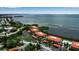 Expansive aerial view of a waterfront condo community, showcasing lush landscaping and beautiful coastal surroundings at 3420 Wild Oak Bay Blvd # 120, Bradenton, FL 34210