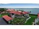 Beautiful aerial view of condos with waterfront access, red tile roofs, and lush landscaping at 3420 Wild Oak Bay Blvd # 120, Bradenton, FL 34210