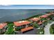 Stunning aerial view of waterfront condos with red tile roofs and lush landscaping overlooking the beautiful bay at 3420 Wild Oak Bay Blvd # 120, Bradenton, FL 34210