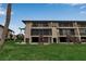 Exterior of condo units featuring screened lanais, stairs, and spacious lawn area at 3420 Wild Oak Bay Blvd # 120, Bradenton, FL 34210