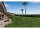 Backyard view of condo building, featuring lush green lawn and steps leading to upper units at 3420 Wild Oak Bay Blvd # 120, Bradenton, FL 34210