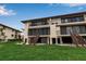 Exterior of condominium building with screen lanais, stairs, and a well-kept lawn at 3420 Wild Oak Bay Blvd # 120, Bradenton, FL 34210